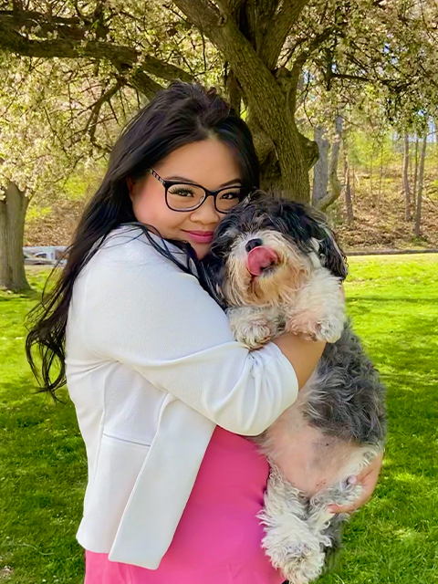 Tariana Nguyen holding a small black and white dog